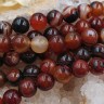 Купить (ОПТ) Бусина округлая ГЛАДКАЯ 10мм Агат Мадагаскарский коньячно-т.коричневый (камни) (НИТЬ) с доставкой по России